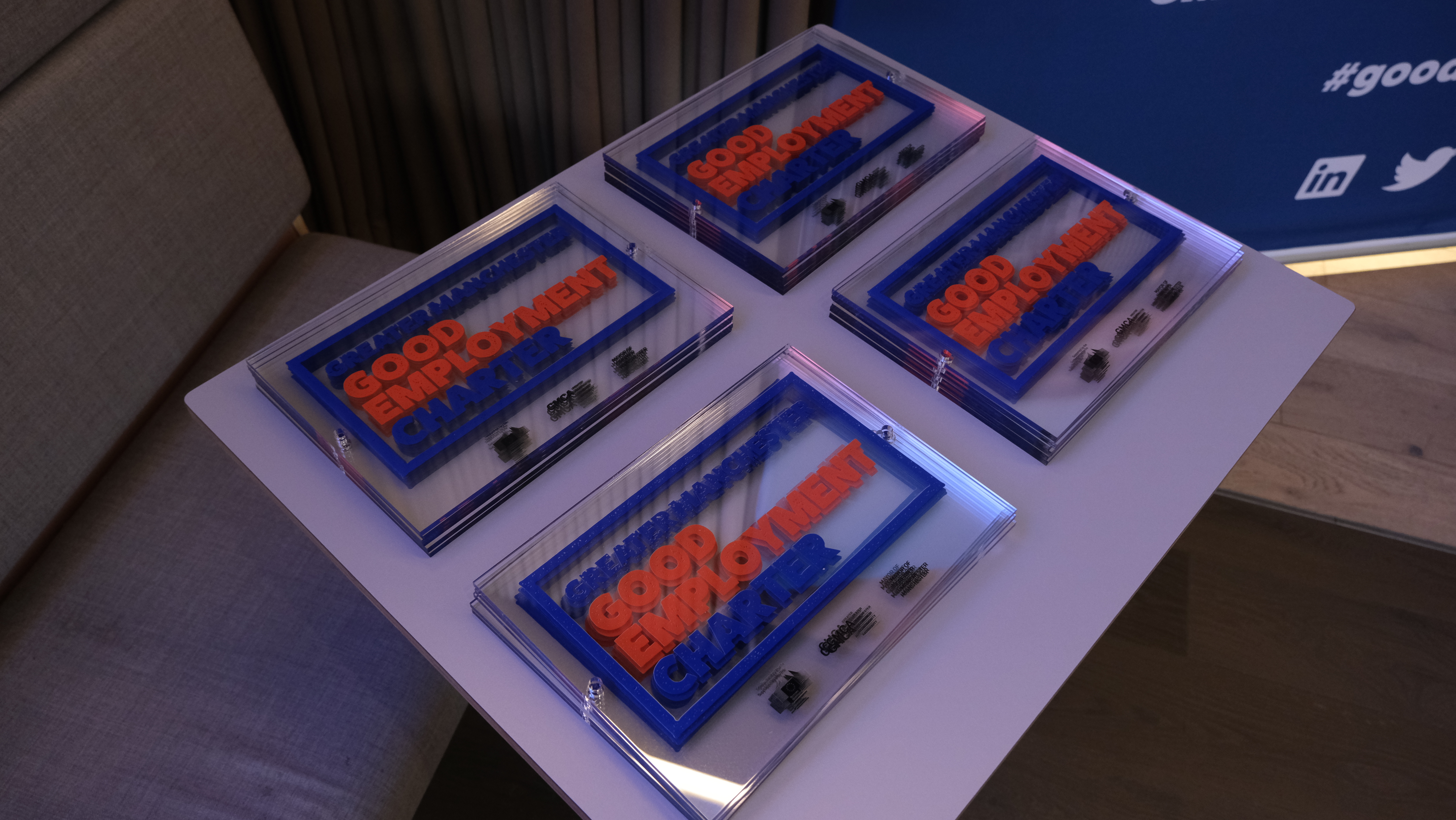 Greater Manchester Good Employment Charter Plaques on a table